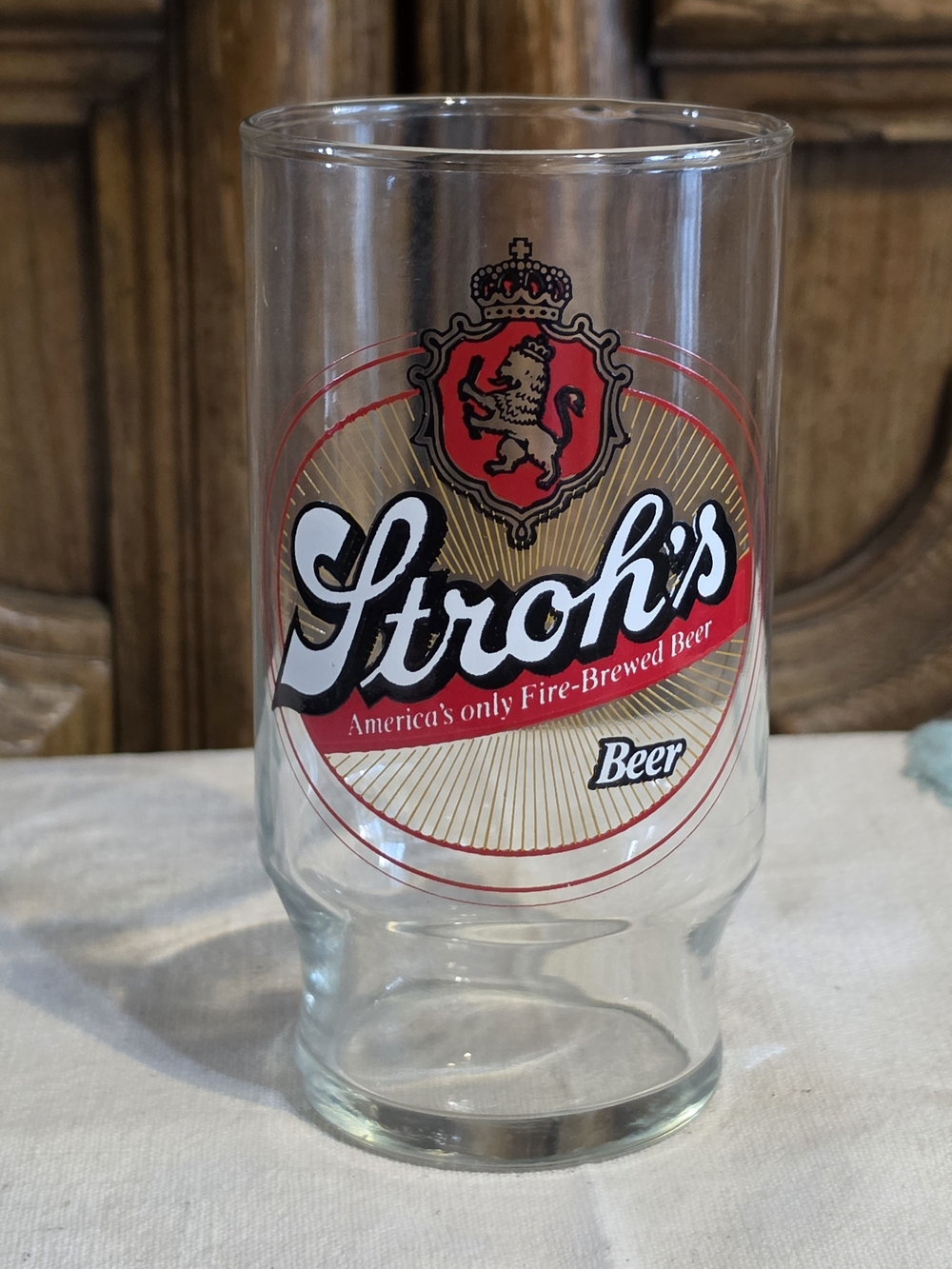 Branded Clear Beer Glass with Red and Gold Crest